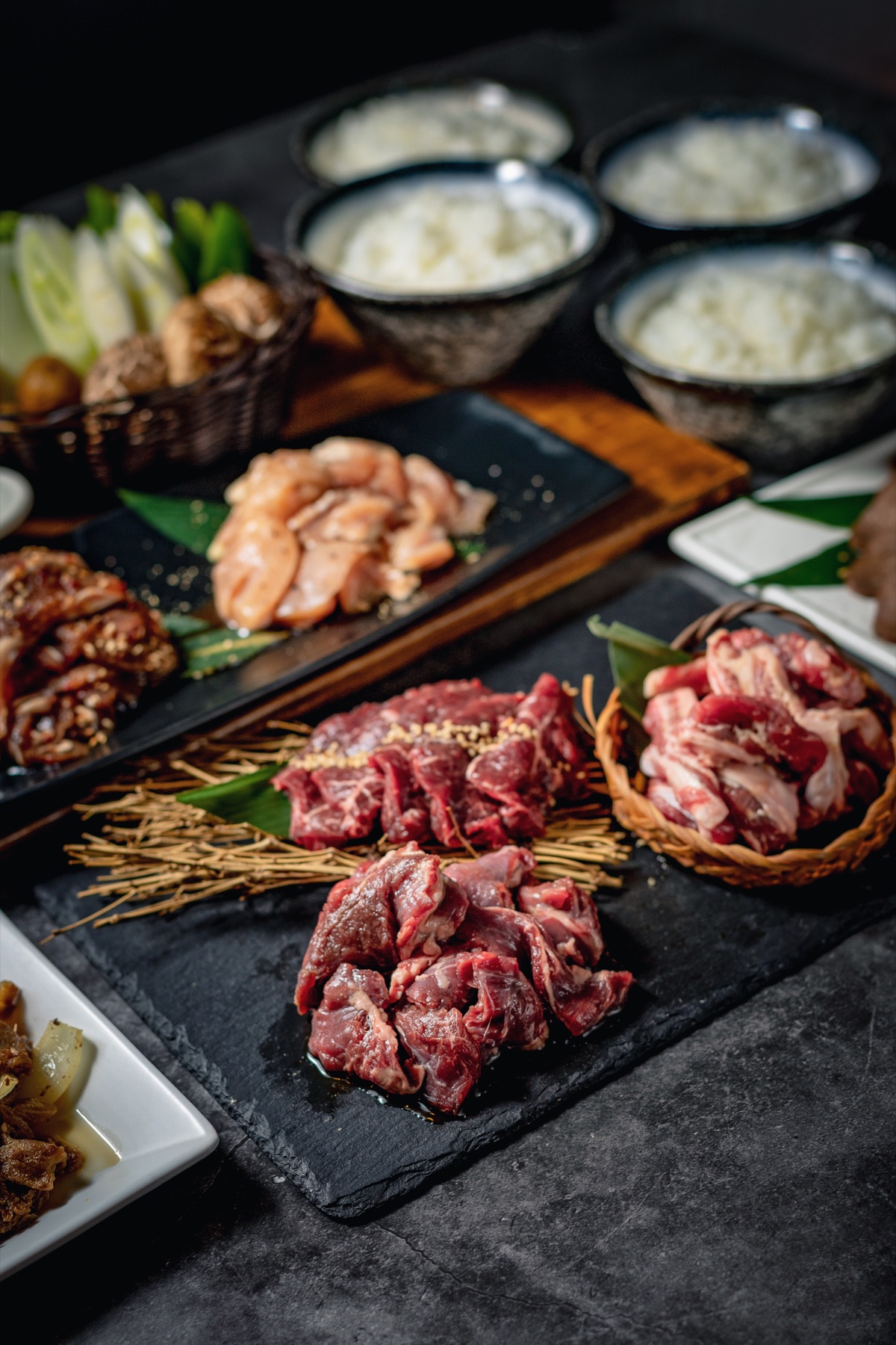 Selection of marinated meats and vegetables prepared for yakiniku grilling