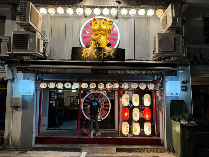 Front entrance of WakuWaku Yakiniku at 27 Bali Lane, Singapore, illuminated at night